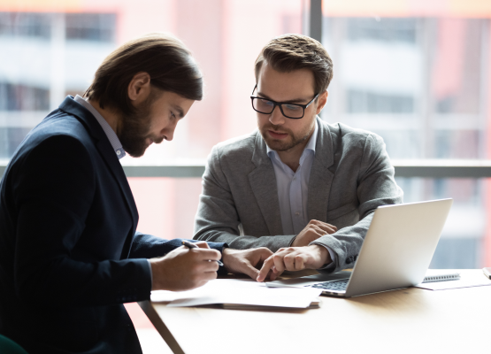 Two professionals discussing a contract